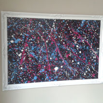 Up cycled antique frame with pollock splash effect on black pain